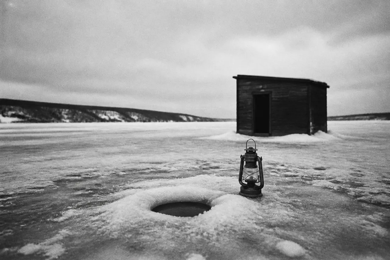 Empty net and one coin beside the Ice Fish hole